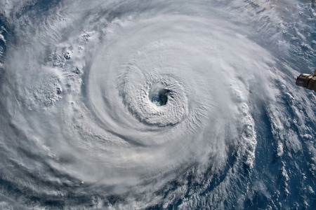 picture of a large hurricane from the top where you can see the center opening up